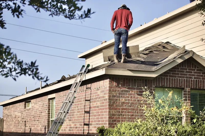 Professional roofer working on a residential roof in Street